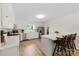 A bright kitchen featuring white cabinets, stainless appliances, a breakfast bar, and hardwood flooring at 111 Kelly Ln, Gastonia, NC 28056