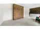 An open-concept living room features carpet floors, white trim and a decorative brick wall at 111 Kelly Ln, Gastonia, NC 28056