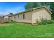 Grassy backyard with vinyl siding and wooden deck at 1116 Crestview Dr, Salisbury, NC 28146