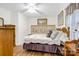 Inviting bedroom with hardwood floors, floral bedding, and soft lighting creating a warm and relaxing ambiance at 1116 Crestview Dr, Salisbury, NC 28146