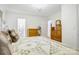 Comfortable bedroom featuring floral bedding, hardwood floors, and vintage wooden dressers offering ample storage at 1116 Crestview Dr, Salisbury, NC 28146