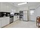 Functional kitchen with white cabinets, stainless steel appliances, and tiled floors offering durability and style at 1116 Crestview Dr, Salisbury, NC 28146