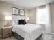 Cozy bedroom showcasing a bed with a patterned comforter and minimalist décor at 1202 Elm Forest Ln, China Grove, NC 28023
