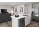 Open-concept living space with a stylish kitchen island, stainless steel appliances, modern finishes, and a comfortable living area at 1202 Elm Forest Ln, China Grove, NC 28023