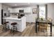 Well-lit kitchen with white cabinetry, stainless appliances, an island with seating, and an adjacent dining area at 1202 Elm Forest Ln, China Grove, NC 28023