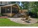 A sprawling backyard with stone patio, built in barbeque, fire pit and screened in back porch at 122 Ringneck Trl, Mooresville, NC 28117