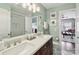 Bright bathroom with a double sink vanity, framed mirror, and a walk-in shower at 122 Ringneck Trl, Mooresville, NC 28117