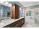 Bathroom with dual sinks, custom vanity, hardwood floors, walk-in shower and freestanding tub at 122 Ringneck Trl, Mooresville, NC 28117