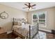 Comfortable bedroom featuring a ceiling fan, hardwood floors, and plenty of natural light at 122 Ringneck Trl, Mooresville, NC 28117