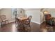 Cozy dining area with a wood table, four chairs, hardwood flooring and natural light at 122 Ringneck Trl, Mooresville, NC 28117