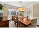 Formal dining room with a large window, hardwood floors, and elegant chandelier at 122 Ringneck Trl, Mooresville, NC 28117