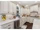 Bright kitchen with white cabinetry, granite countertops, stainless steel appliances, and a large window at 122 Ringneck Trl, Mooresville, NC 28117
