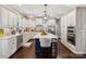 Beautiful kitchen with white cabinets, stainless steel appliances, and a dark blue island with a white countertop at 122 Ringneck Trl, Mooresville, NC 28117