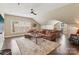 Spacious living room featuring hardwood floors, a ceiling fan, and comfortable leather furniture at 122 Ringneck Trl, Mooresville, NC 28117