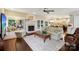 Spacious living room with fireplace, hardwood floors, french doors, and open view to the kitchen at 122 Ringneck Trl, Mooresville, NC 28117