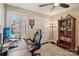 Well-lit office space with a large desk, comfortable chair, and built-in bookcase at 122 Ringneck Trl, Mooresville, NC 28117