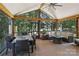 Relaxing screened patio with outdoor dining and seating, offering views of the surrounding woods at 122 Ringneck Trl, Mooresville, NC 28117