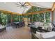 Inviting outdoor patio with a screened roof, comfortable seating, and dining area at 122 Ringneck Trl, Mooresville, NC 28117