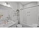 Clean, bright bathroom with white tile, modern fixtures, and a shower-tub combo at 12615 Es Draper Dr, Huntersville, NC 28078