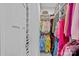 Walk-in closet with clothes hanging on hangers, shelves full of shoes, and shelves with accessories at 12615 Es Draper Dr, Huntersville, NC 28078