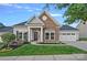 Charming home with stone accents, manicured lawn, and a well-maintained landscape offers curb appeal at 12615 Es Draper Dr, Huntersville, NC 28078