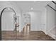 Bright and airy foyer with arched doorways, wood floors, and elegant staircase at 12615 Es Draper Dr, Huntersville, NC 28078