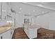 A kitchen features an island with granite countertops, white cabinets, and stainless steel appliances at 12615 Es Draper Dr, Huntersville, NC 28078