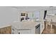 A kitchen island features granite countertops, stainless steel appliances, and a view of a living room with a fireplace at 12615 Es Draper Dr, Huntersville, NC 28078
