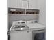 Clean laundry room featuring front-load washer and dryer with extra storage at 12615 Es Draper Dr, Huntersville, NC 28078