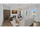 Living room with a fireplace, large windows, a modern chandelier, and dark wooden cabinets on either side of the fireplace at 12615 Es Draper Dr, Huntersville, NC 28078