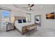 A main bedroom features a large bed, carpeted floor, decorative ceiling fan, and a large decorative mirror at 12615 Es Draper Dr, Huntersville, NC 28078