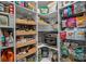 A pantry features shelves full of various food items, drawers with various food items, and a built-in microwave at 12615 Es Draper Dr, Huntersville, NC 28078
