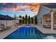 Relaxing poolside area with a fire pit, hot tub, and lounge chairs, creating a serene outdoor retreat at 12615 Es Draper Dr, Huntersville, NC 28078