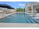 A stunning pool area features lounge chairs, waterfall features and an outdoor kitchen to provide outdoor enjoyment at 12615 Es Draper Dr, Huntersville, NC 28078