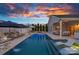 Backyard pool with an outdoor kitchen, lounge seating, and stunning sunset views at 12615 Es Draper Dr, Huntersville, NC 28078