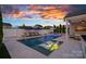 Stunning backyard with a pool, spa, fire features, and various seating options for ultimate relaxation and enjoyment at 12615 Es Draper Dr, Huntersville, NC 28078