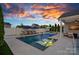 Beautiful backyard with a pool, spa, lounge chairs, and fire bowls, perfect for outdoor entertaining at 12615 Es Draper Dr, Huntersville, NC 28078