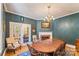 Dining room with a fireplace, chandelier, and glass french doors leading to another room at 1282 W Hwy 27 Hwy, Lincolnton, NC 28092