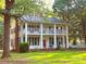 Charming two-story home with a double-decker porch and a red front door at 1282 W Hwy 27 Hwy, Lincolnton, NC 28092