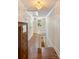 Hallway with hardwood floors, white trim, and a decorative chandelier at 1282 W Hwy 27 Hwy, Lincolnton, NC 28092