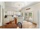 Kitchen features island, white cabinets, chandelier, and access to outdoor area at 1282 W Hwy 27 Hwy, Lincolnton, NC 28092