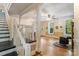 Spacious living room with bright natural light, beautiful fireplace, and staircase at 1282 W Hwy 27 Hwy, Lincolnton, NC 28092