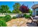 This backyard features a landscaped garden with stone pathway, patio area, and privacy fence at 1313 Haywood Park Rd, Marvin, NC 28173