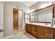 This bathroom features a double vanity with a wooden cabinet, a large mirror, and a separate shower at 1313 Haywood Park Rd, Marvin, NC 28173