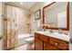 Well-lit bathroom featuring a shower-tub combo, vanity with sink, and neutral tile at 1313 Haywood Park Rd, Marvin, NC 28173