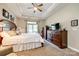 Bright and airy bedroom with a tray ceiling, large bed, and windows overlooking the yard at 1313 Haywood Park Rd, Marvin, NC 28173
