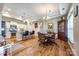 Open-concept dining area with hardwood floors, elegant lighting, and seamless transition to kitchen at 1313 Haywood Park Rd, Marvin, NC 28173