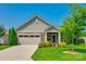 Charming single-story home featuring a stone-accented facade, two-car garage, and well-manicured lawn at 1313 Haywood Park Rd, Marvin, NC 28173