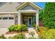 Inviting front porch with decorative plants and stone accents on the home's exterior create an inviting entrance at 1313 Haywood Park Rd, Marvin, NC 28173