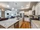 Spacious kitchen boasts a large island with granite countertops, stainless steel appliances, and hardwood floors at 1313 Haywood Park Rd, Marvin, NC 28173